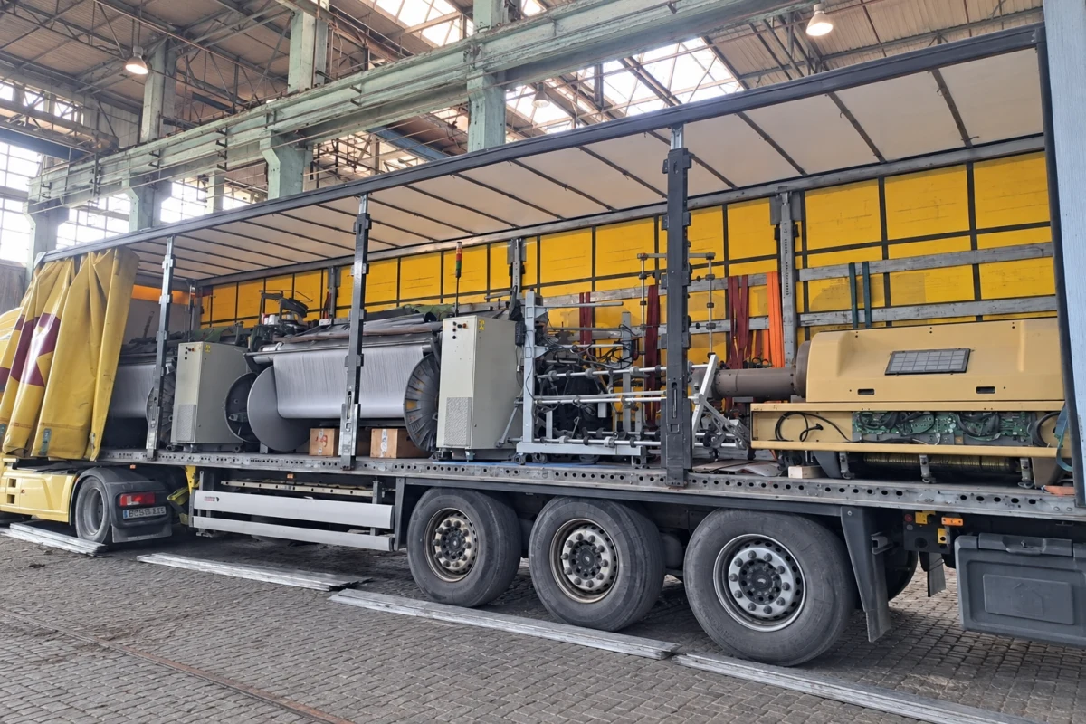Unpacked textile machinery prepared for unloading from a truck